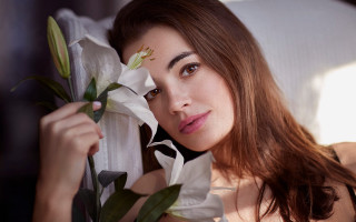 Woman holding lily smiling portrait - annabel eyres free wallpaper