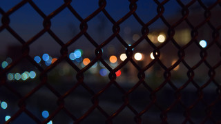 Blurry city night fence lights - a fence free wallpaper for desktop