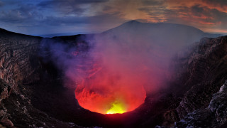 Lava crater glow mountains clouds - yellow free wallpaper