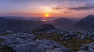 Sunset mountain lake river shore - rock and grass free wallpaper