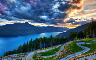 Scenic winding road lake sunset - a lake in the background free wallpaper