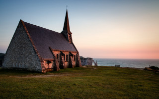 Church steeple grassy hill ocean - a church free wallpaper