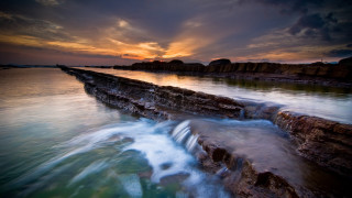 Sunset water rocks wave cityscape - the foreground and a body of water free wallpaper for desktop