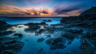 Sunset rocky beach mystical colors 7 - a colorful sky in the background free wallpaper