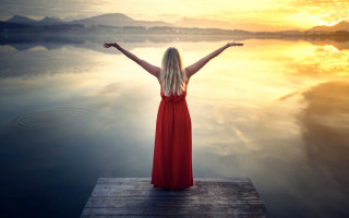 Woman dock red dress outstretched - free sunset wallpaper