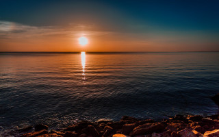 Sunset ocean rock person lens - a sunset over the ocean free wallpaper