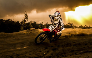 Dirtbike riding cloudy sky trees - a dirt bike free wallpaper