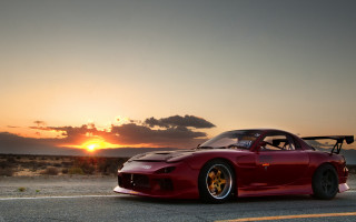 Red sports car sunset clouds 2 - a parking lot free wallpaper