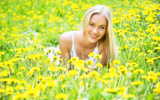 Woman field yellow flowers smiling - her face and a smile free wallpaper