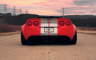 Red sports car sunset ocean - the side of a road free wallpaper