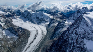 Mountain range glacier clouds plane - a plane window free wallpaper