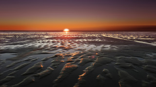 Sunset beach reflection clouds ocean - a sunset over a beach free wallpaper