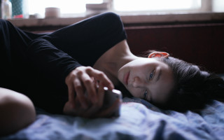 Woman lying bed holding phone - charles angrand free wallpaper