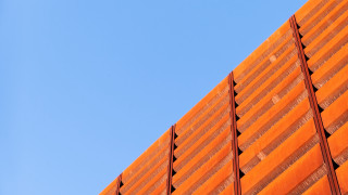 Red building blue sky plane - overhead in the distance free wallpaper