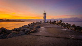 Lighthouse pier sunset clouds water - a pier free wallpaper for desktop