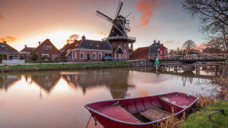 Boat shore river windmill houses - a sunset free wallpaper for desktop