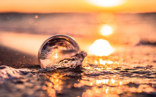 Water drop beach sunset reflection - a close up of a water drop free wallpaper