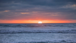 Sunset ocean wave beach city - free sunset wallpaper