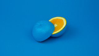 Orange half eaten blue surface - two orange free wallpaper