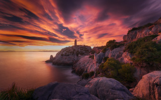 Lighthouse rocky cliff sunset water - a rocky cliff free wallpaper