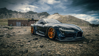Black sports car rocky mountain - a horse in the background free wallpaper