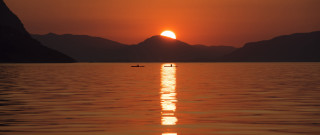 Boat sunset mountains person water - a boat free wallpaper for desktop