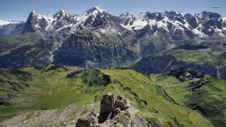 Mountain range valley snow capped - a view of a mountain range free wallpaper