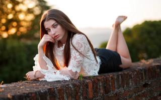 Woman brick wall crossed legs - arabella rankin free wallpaper