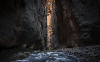 Narrow river canyon door cave - deep shadow free wallpaper