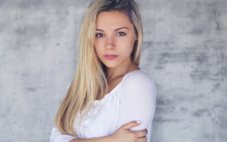 Blonde woman crossed arms concrete - free portrait wallpaper for desktop