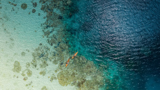 Boat beach rocks ocean night - a blue ocean free wallpaper