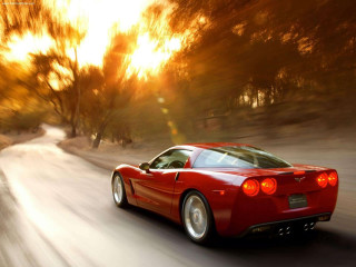 Red sports car driving road 30 - motion blur free wallpaper for desktop
