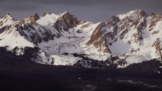 Snowy mountain range forest cloudy - dramatic light free wallpaper for desktop