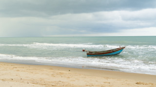 Shore waves boat beach cloudy - stormy weather free wallpaper for desktop