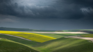 Green field road stormy sky - a few cloud above free wallpaper