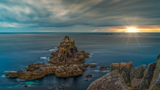 Rock formation ocean lighthouse clouds - a lighthouse in the distance free wallpaper