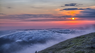 Hill clouds sunset sky planet - a bright sun in the distance free wallpaper