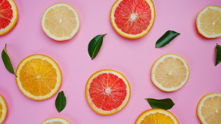 Citrus halves pink background leaves - a pink surface free wallpaper