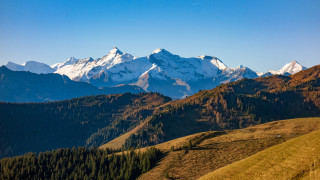Mountain range snow capped grassy 2 - free mountains wallpaper
