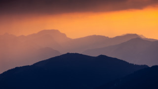 Mountain range sunset clouds orange - a dark cloud in the sky above free wallpaper