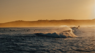 Surfing group wave ocean sunset - in the ocean free wallpaper