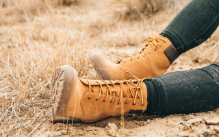 Person brownboots blackpants crossedlegs drygrass - claire hummel free wallpaper