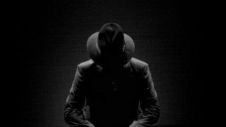 Hooded sitter darkroom black and - film noir free wallpaper