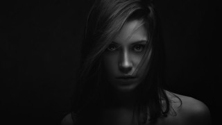 Woman serious black background bw - her face and shoulders free wallpaper