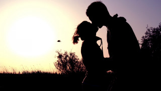 Man woman kissing sunset bird - the sky behind them free wallpaper