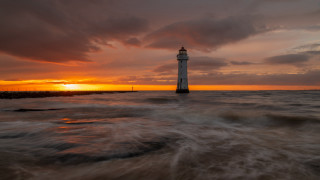 Lighthouse ocean sunset cloudy sky - radiant free wallpaper
