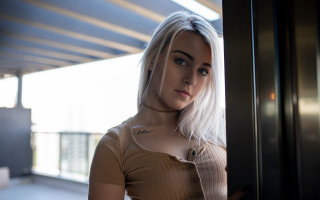 White hair woman piercings portrait - a window behind her free wallpaper