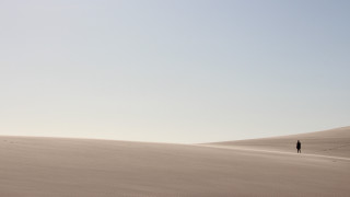 Desert lone person sand dunes 2 - a clear sky free wallpaper