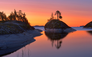 Sunset water trees rocks autumn - a sunset over a body of water free wallpaper