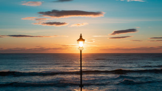 Ocean sunset lighthouse waves reflection - a street light free wallpaper